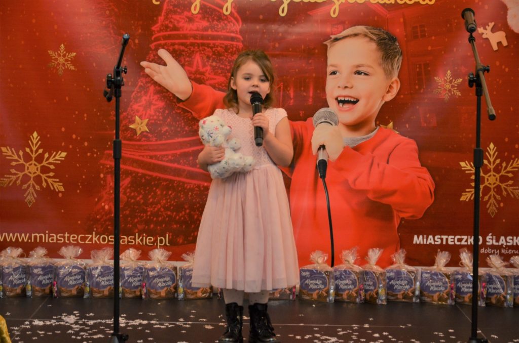 mała dziweczynka , przedszkolak śpiewa piosenke na scenie